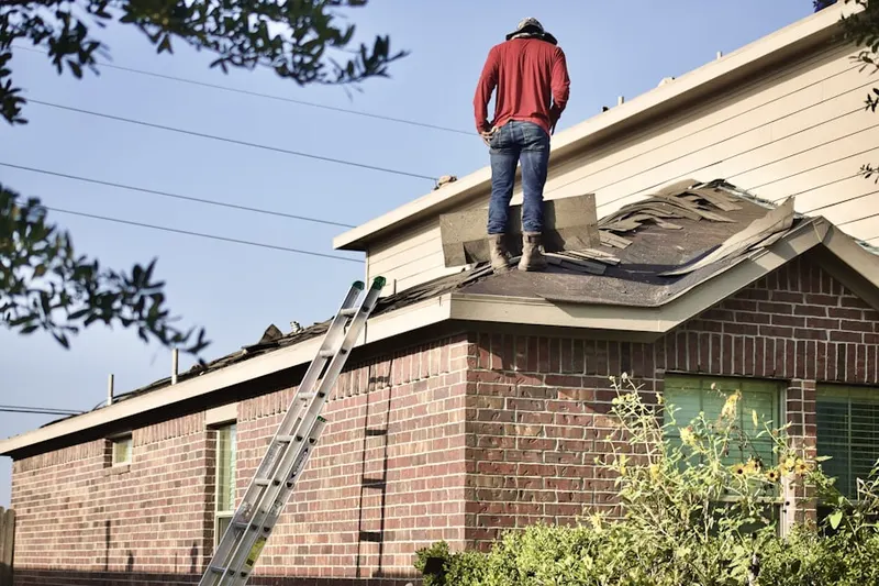 Professional roofer working on a residential roof in Shepperd